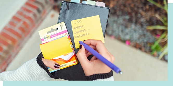 Writing a quick note on the street to-do list checking.
